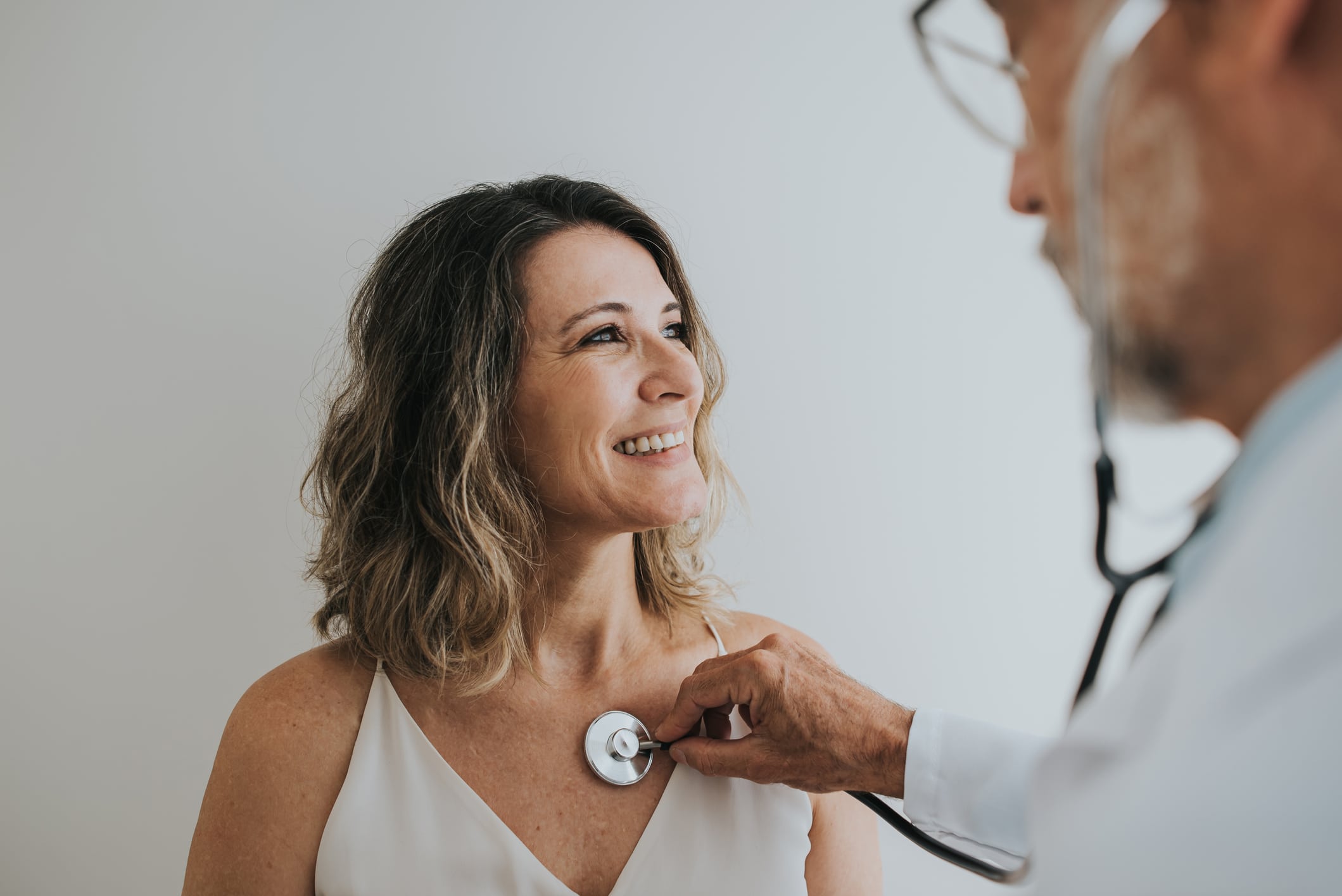 a doctor using a stethoscope on his patient