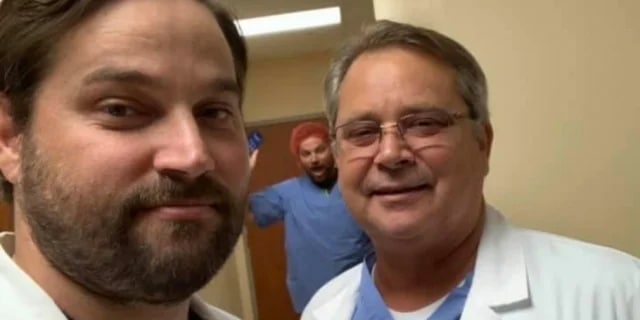 3 men smiling in a hospital room