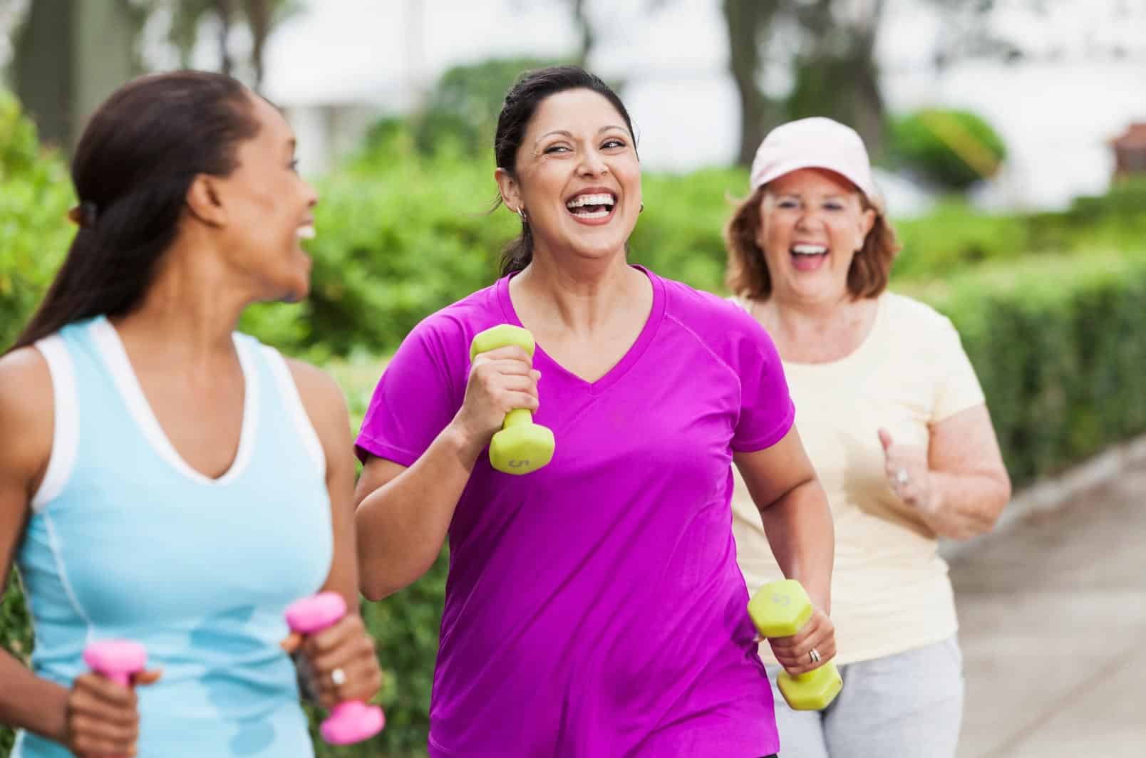 3 women walking and carrying weights