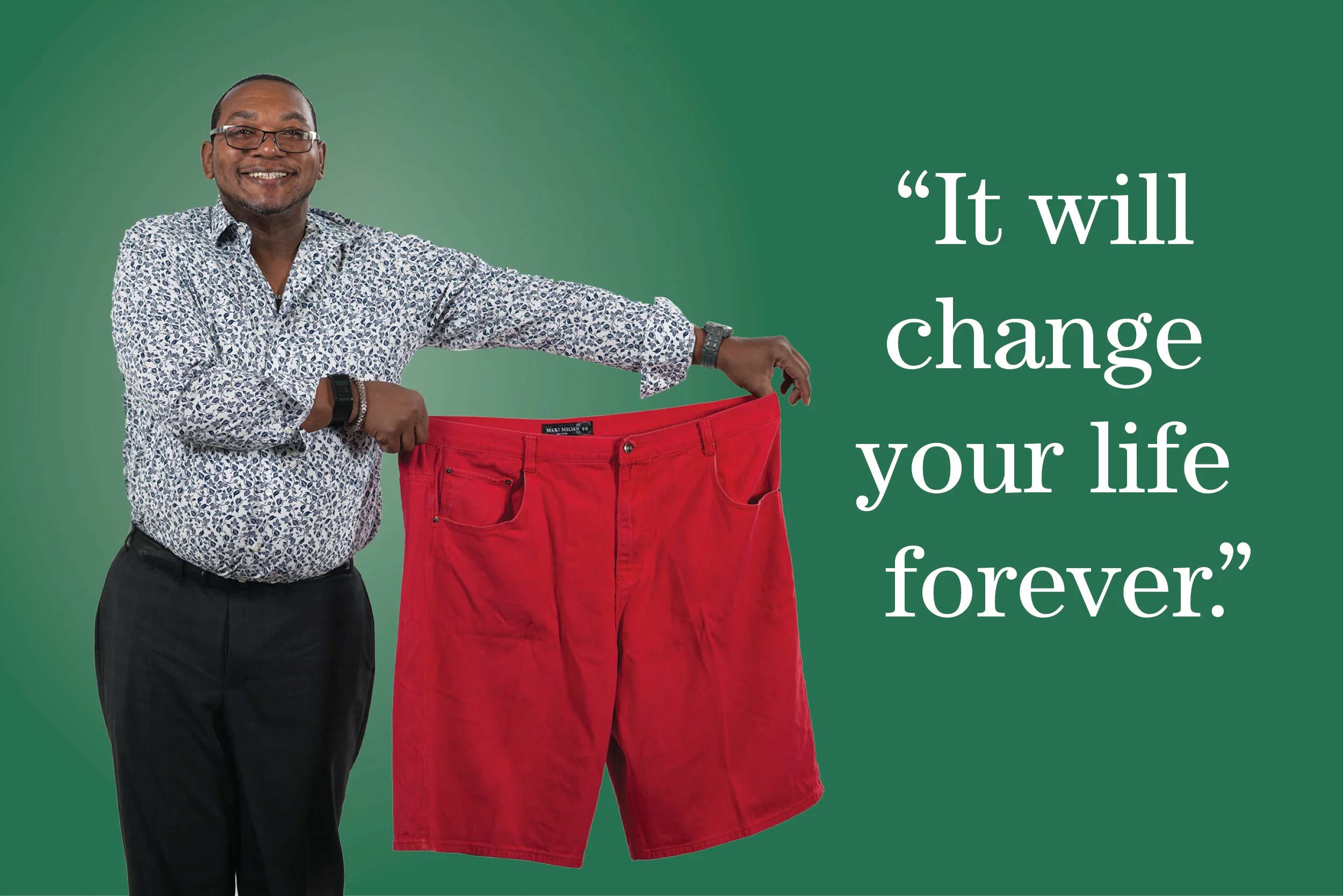 man holding up red shorts that are several sizes too big for him