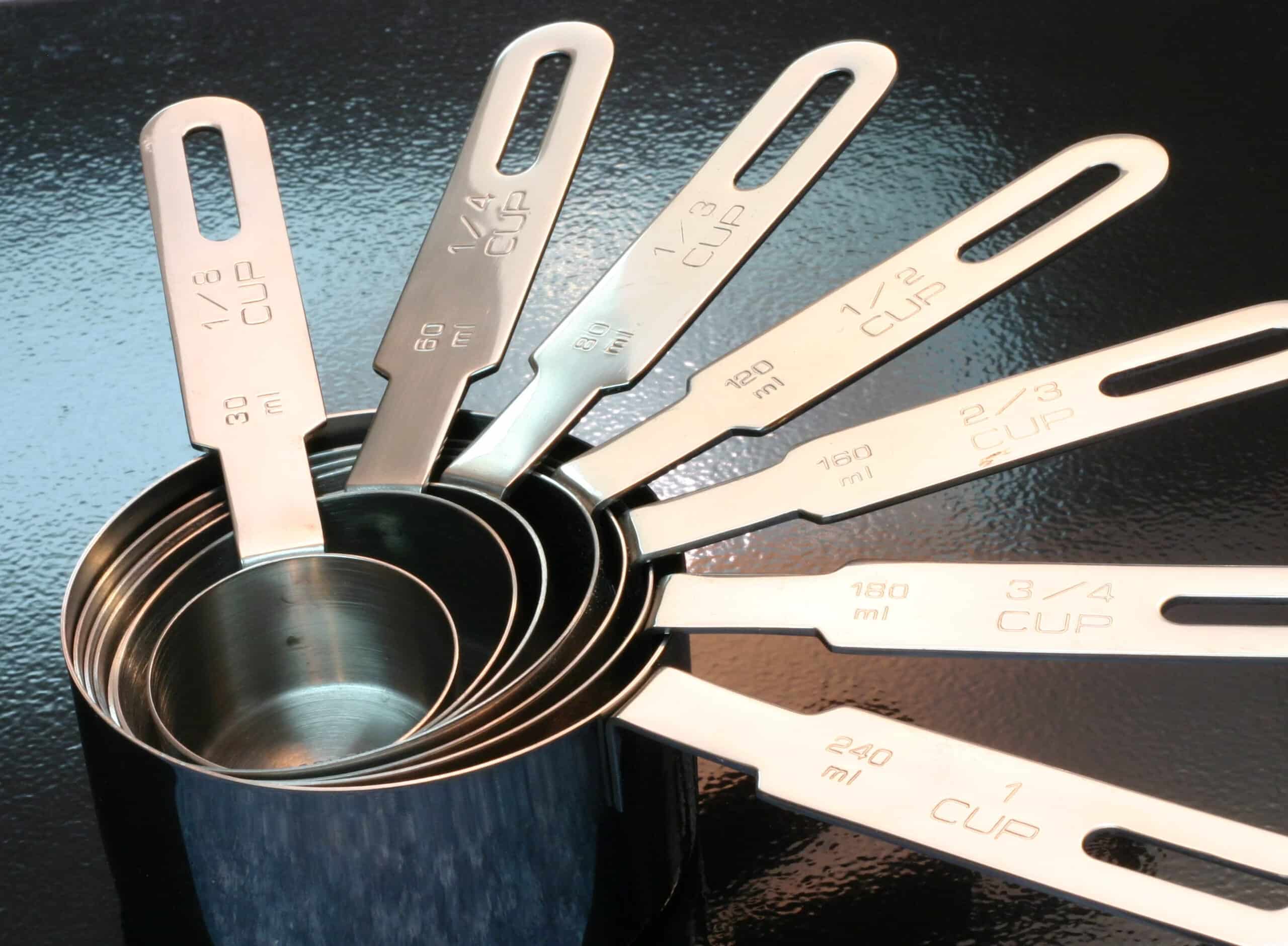 a full set of silver measuring cups