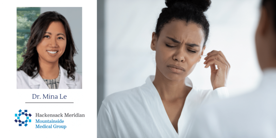 woman using swab in her ear