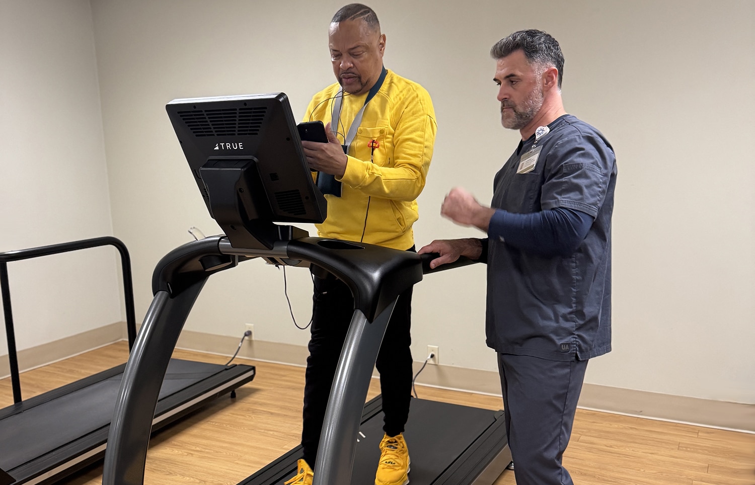 Patient working out on cardiac rehabilitation equipment.
