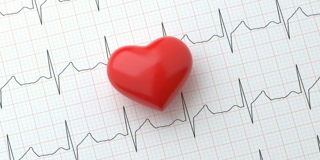 heart figurine on top of a heart beat monitor line print out
