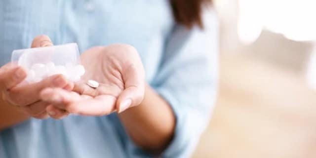 woman taking a pill
