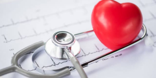 stethoscope next to a heart figurine