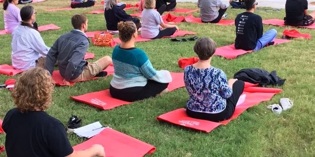 yoga class sitting on red mats