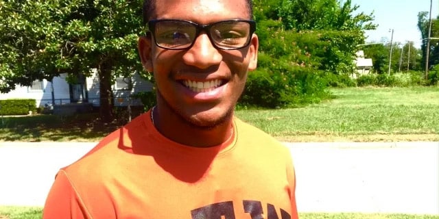 teenager outside smiling