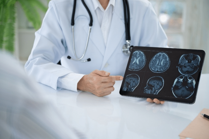 Clinician discussing brain scans displayed on a tablet