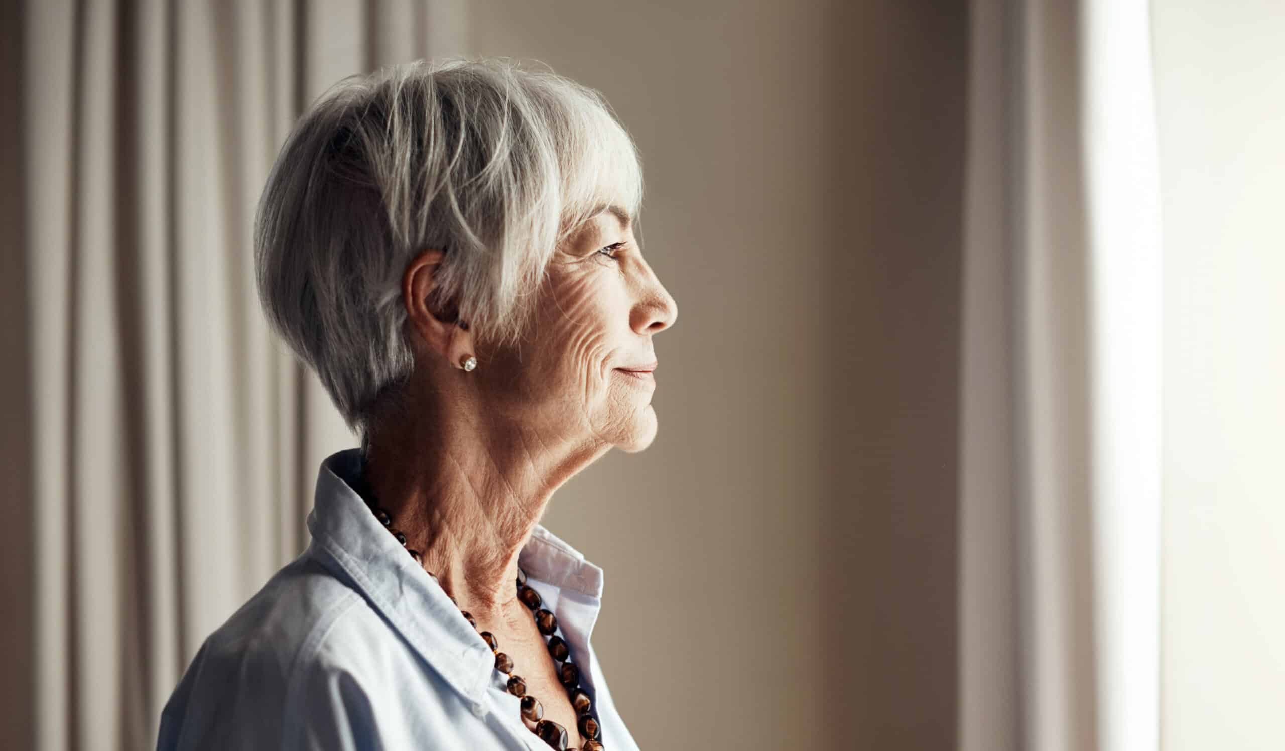 Older woman looking out the window