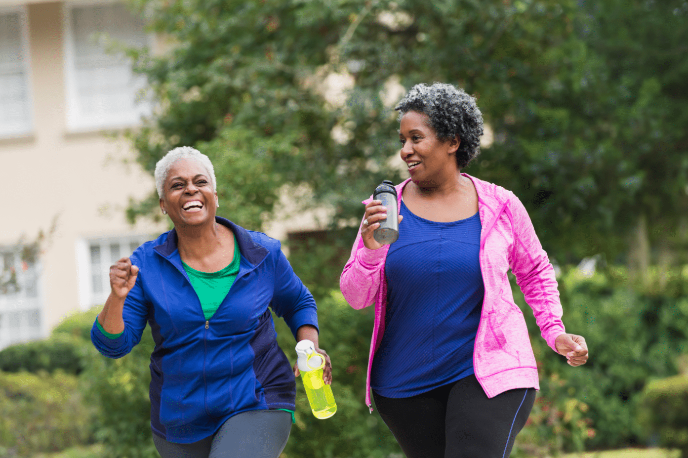 two woman exercising outside