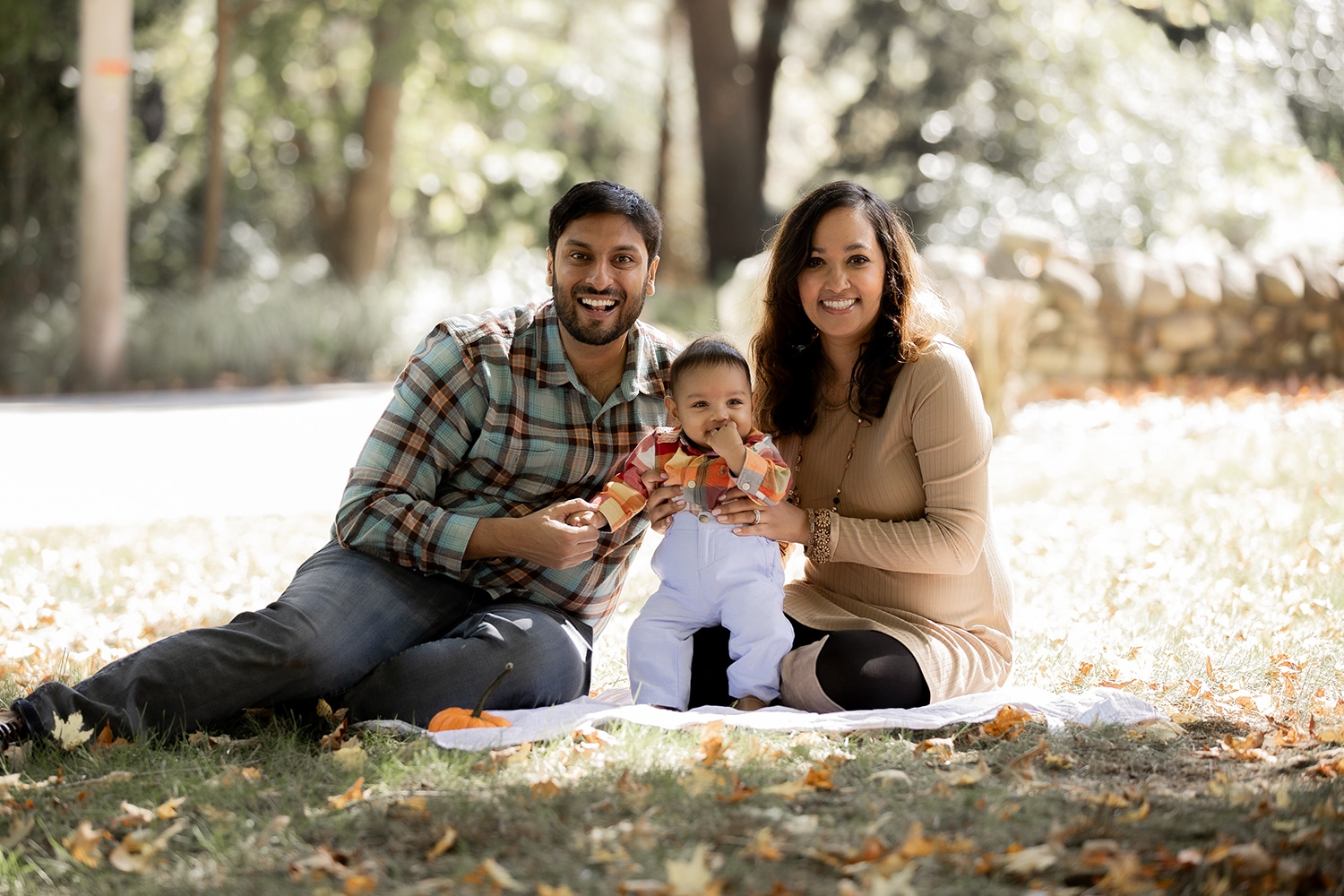 Farah and Tahir Qadeer enjoy a sunny day in the park with their son.