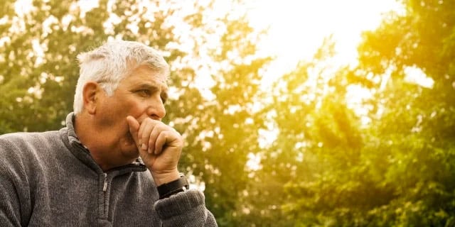 man coughing