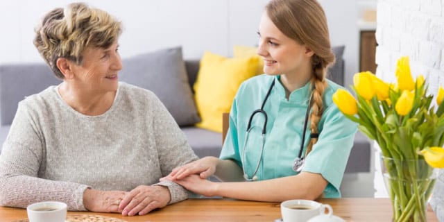 doctor comforting elderly patient