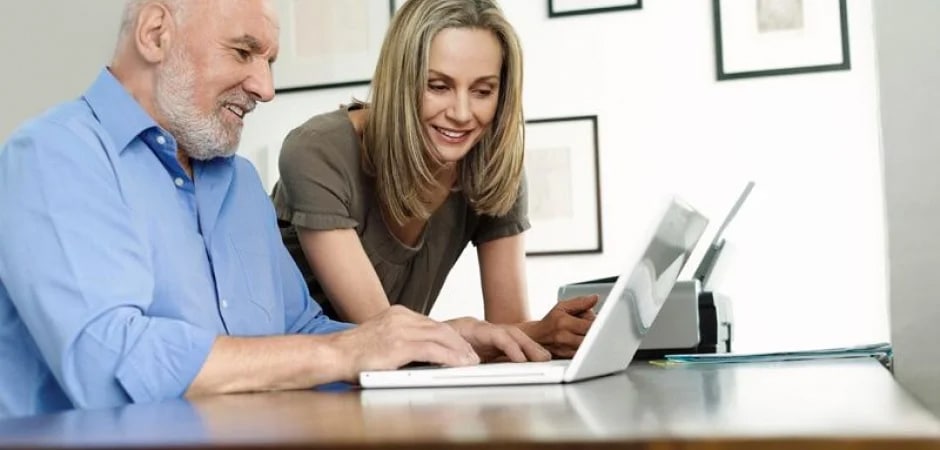 man and woman looking at a computer