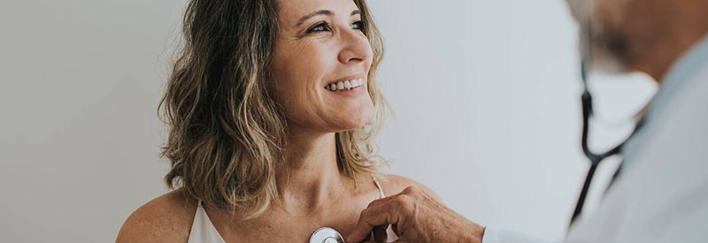 a woman smiling at her doctor