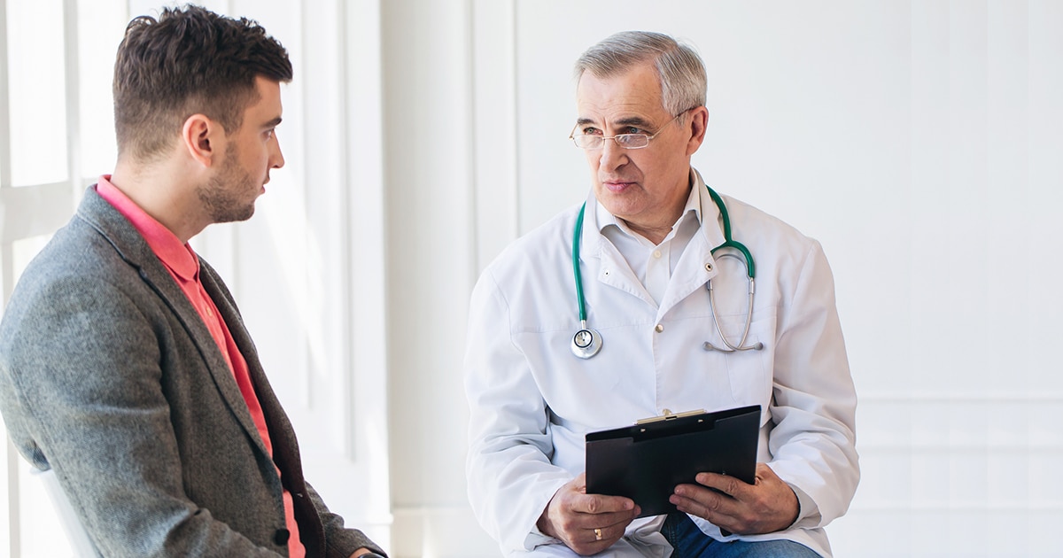 male doctor speaking to male patient